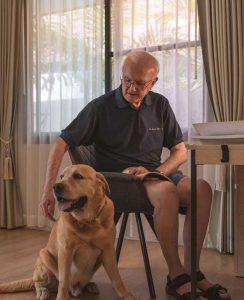 Senior gentleman with his dog at Homerly pets-allowed retirement home in Thailand