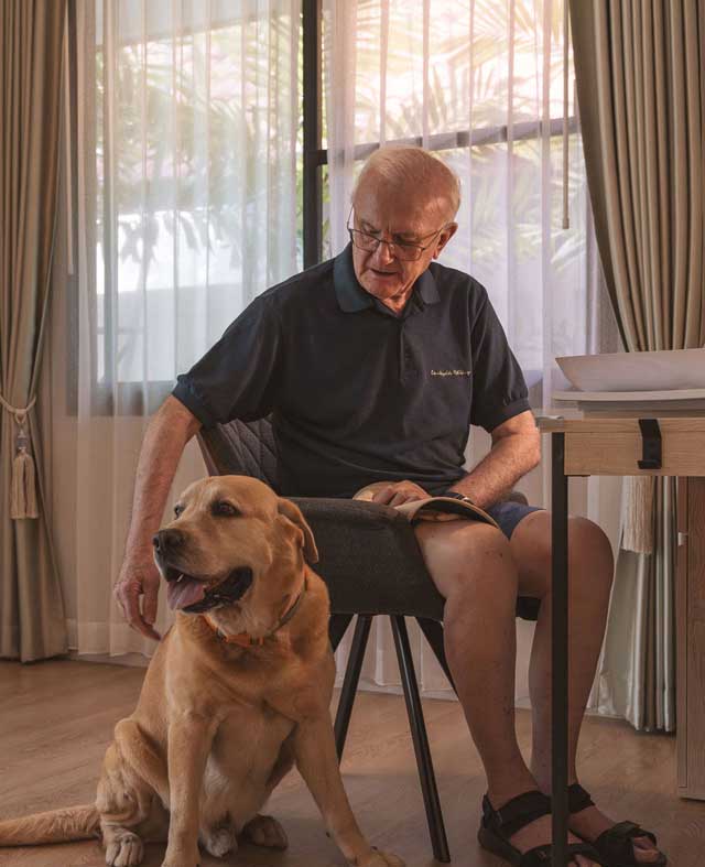 Senior gentleman with his dog at Homerly pets-allowed retirement home in Thailand