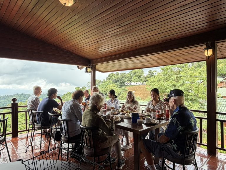Residents enjoying lunch together overlooking the mountain landscape of Chiang Rai