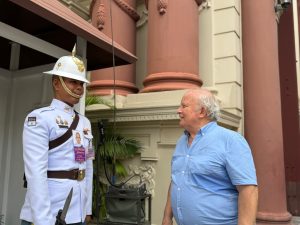 Homerly resident posing beside a Royal Guard at the Grand Palace in Bangkok