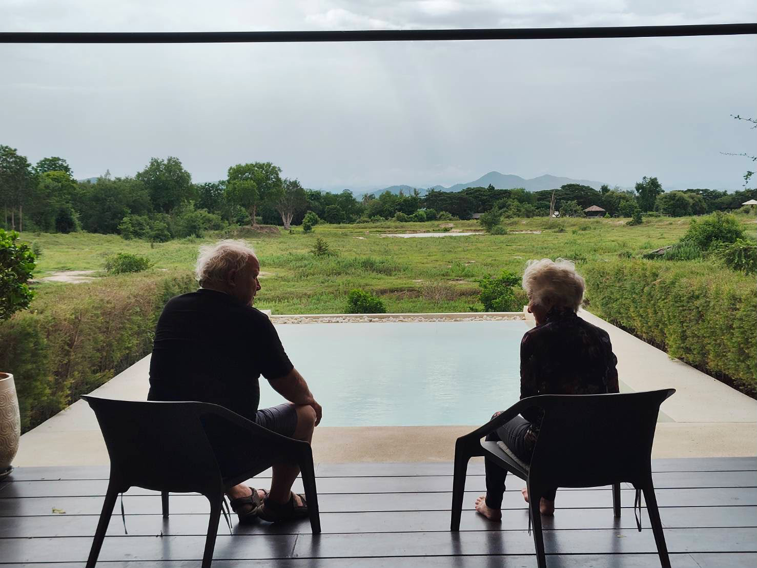 Two Homerly residents sitting together overlooking open countryside near the wildlife sanctuary