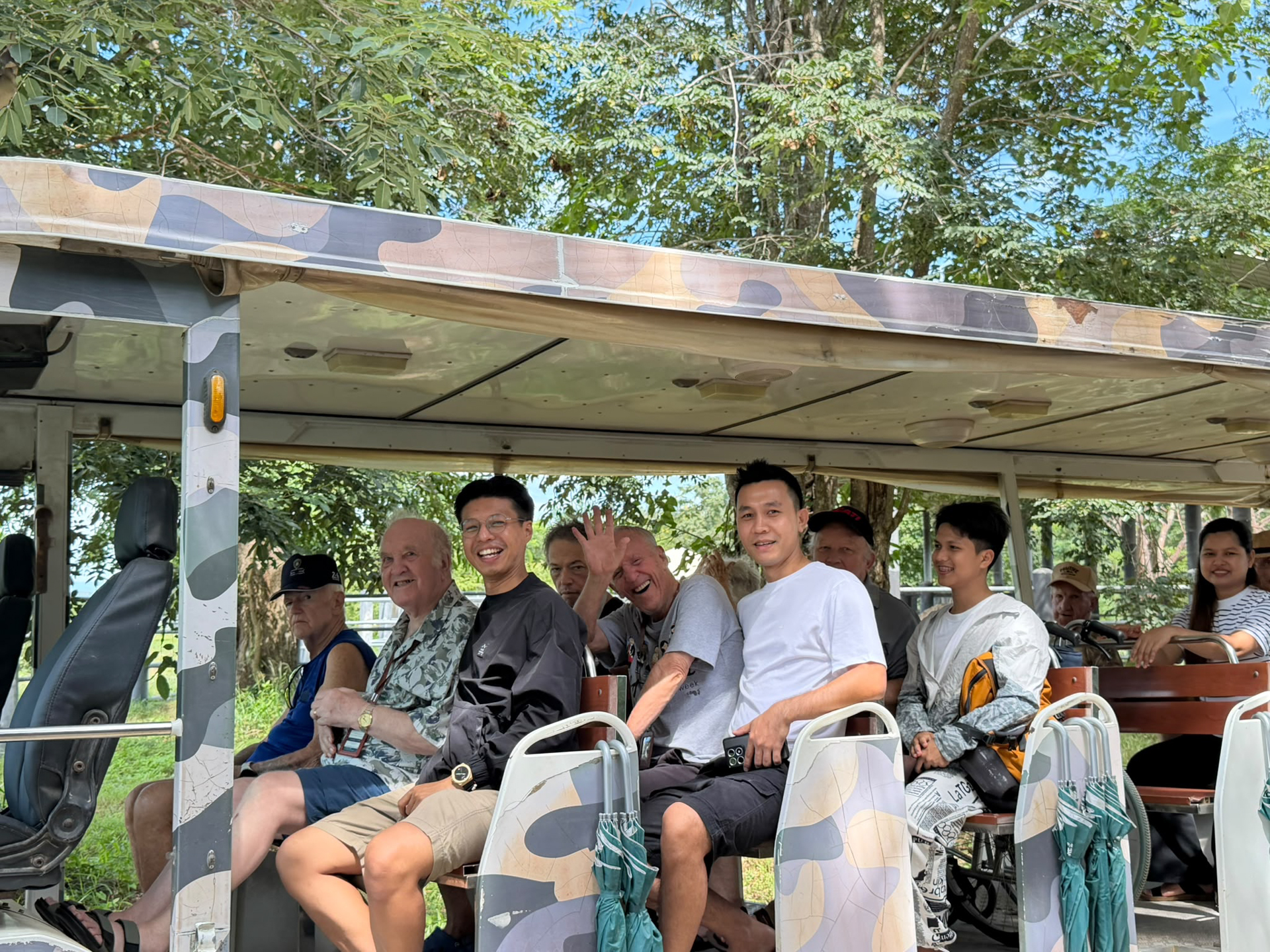 Homerly residents and staff riding the open-air tram together at the wildlife sanctuary